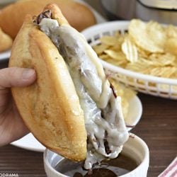french dip sandwich made in the instant pot with melted provolone cheese dipped in homemade beef gravy
