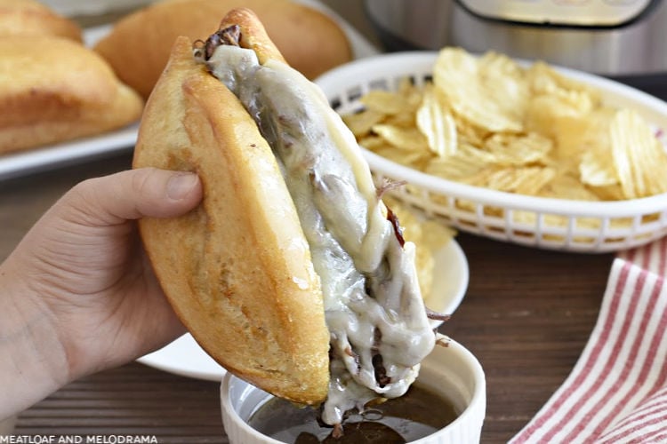 french dip sandwich made in the instant pot with melted provolone cheese dipped in homemade beef gravy