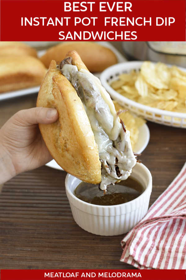 instant pot french dip sandwich with provolone cheese on a french roll dipped au jus
