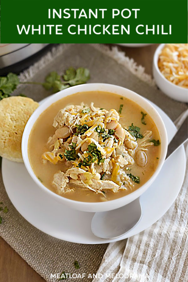 close up of white chicken chili in a bowl for pinterest