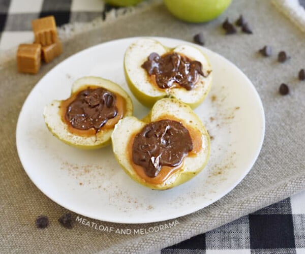 baked chocolate caramel apple halves topped with sea salt on a plate