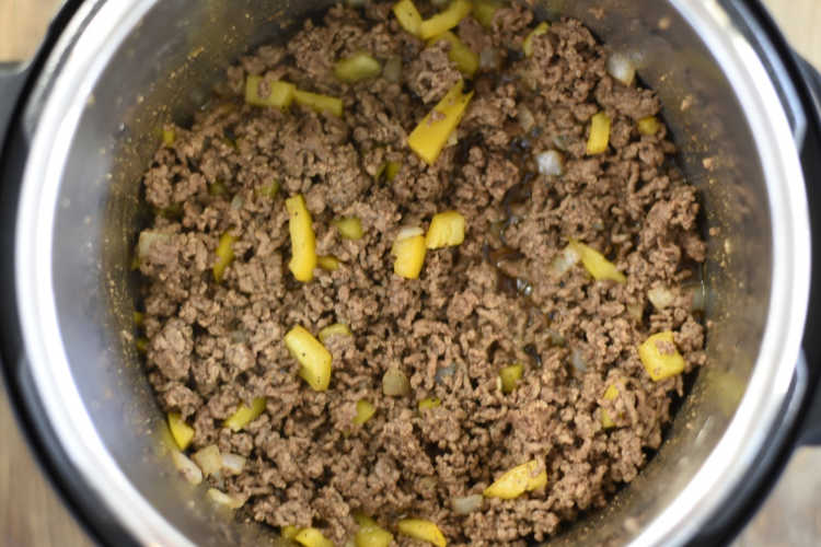 ground beef and chopped yellow peppers in the instant pot pressure cooker