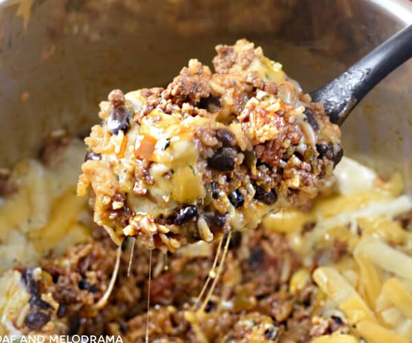 instant pot mexican ground beef and rice with black beans on a spoon in the pressure cooker