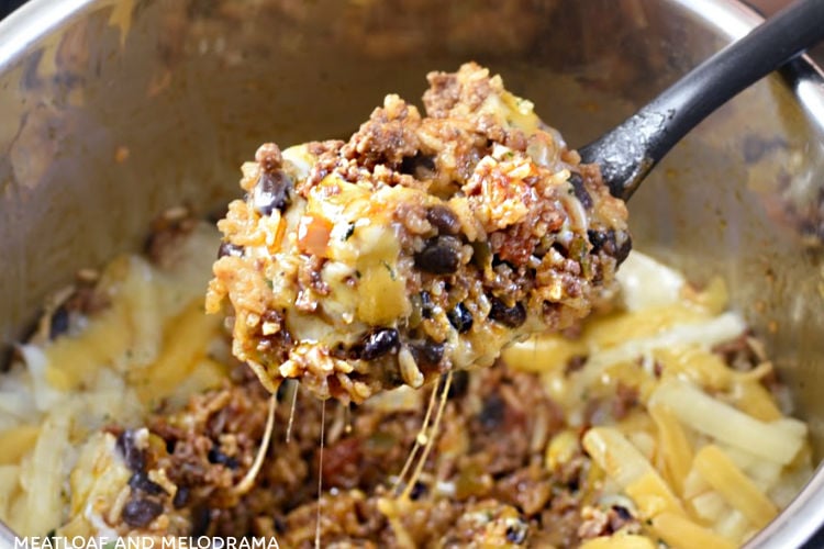 instant pot mexican ground beef and rice with black beans on a spoon in the pressure cooker