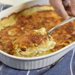 potatoes au gratin on a serving spoon