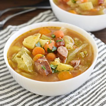 bowl of instant pot kielbasa cabbage soup with potatoes and carrots