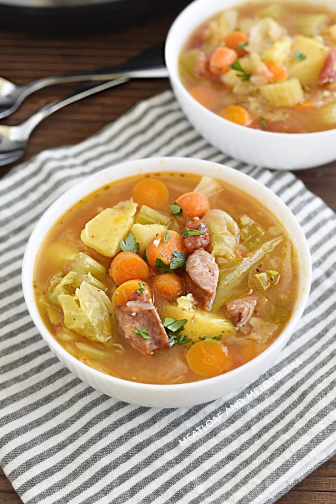 pressure cooker kielbasa cabbage soup with potatoes and carrots in a white bowl