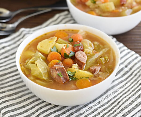 bowl of instant pot kielbasa cabbage soup with potatoes and carrots