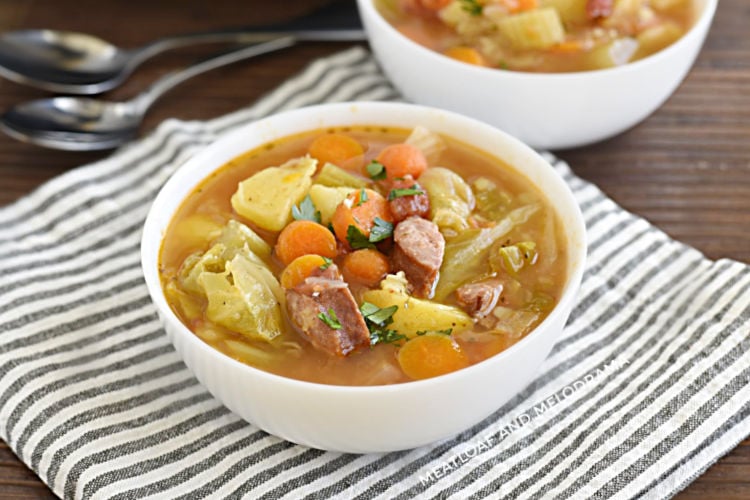 bowl of instant pot kielbasa cabbage soup with potatoes and carrots