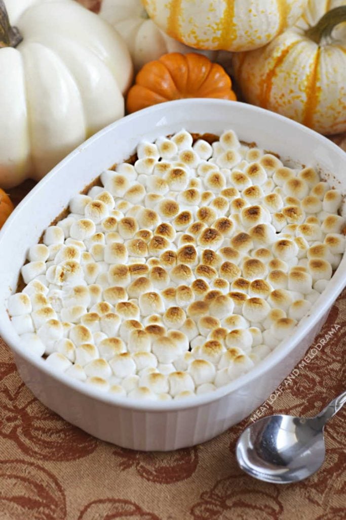 marshmallow topped sweet potato casserole in a white baking dish
