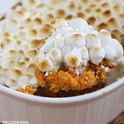 sweet potato casserole with marshmallow topping on a serving spoon
