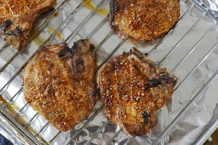 cooked bone in pork chops on oven rack