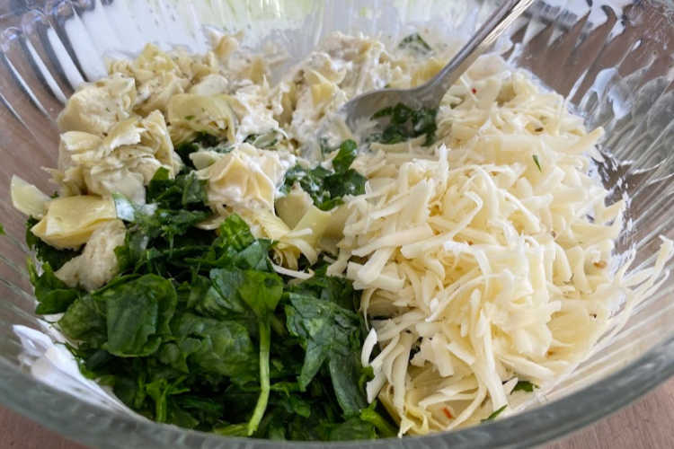 mix fresh spinach, artichoke hearts and pepper jack cheese for dip in bowl
