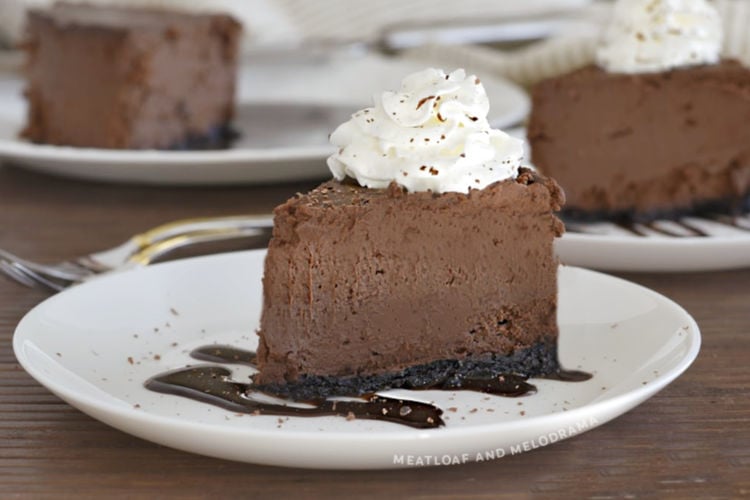 slice of instant pot chocolate cheesecake with whipped cream on a white plate