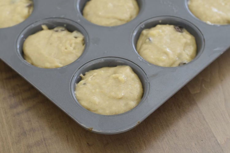 banana muffins with chocolate chips batter in muffin tin
