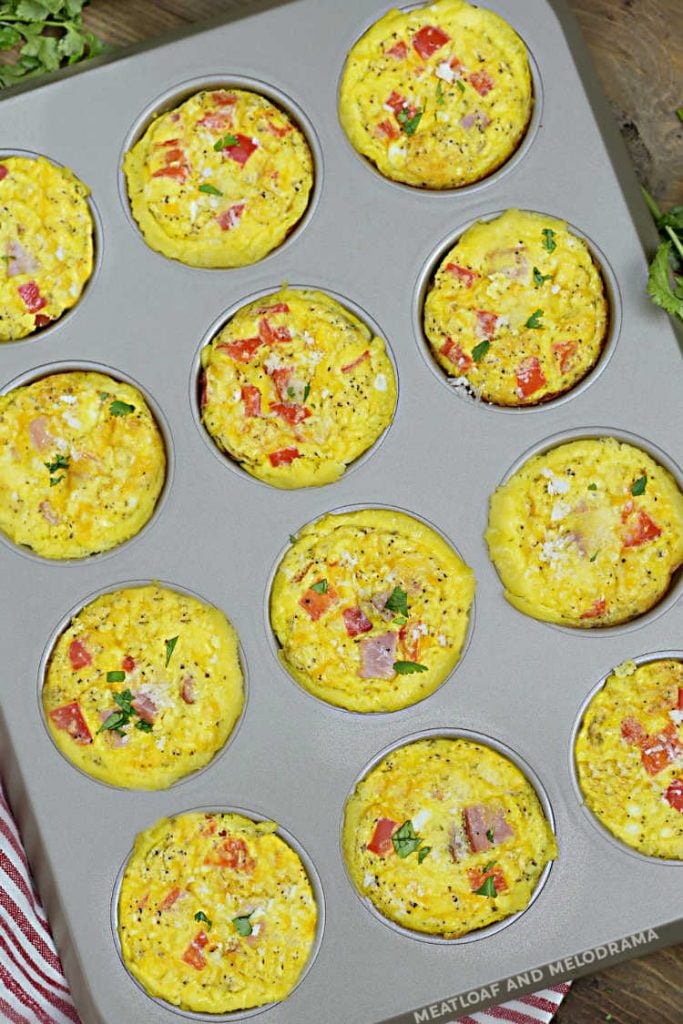 ham and egg muffins with red peppers baked in a muffin tin