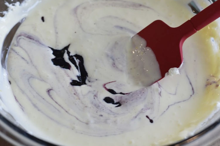 mix and swirl blueberry jam into cheesecake batter with spatula