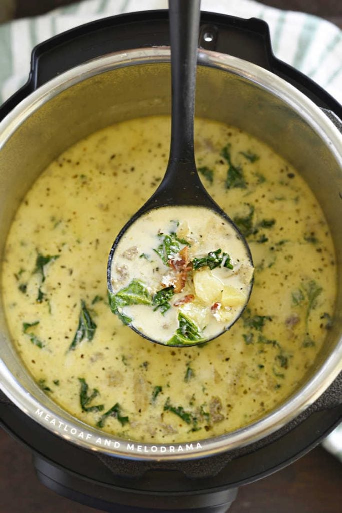 zuppa toscana with kale and bacon in a ladle over instant pot