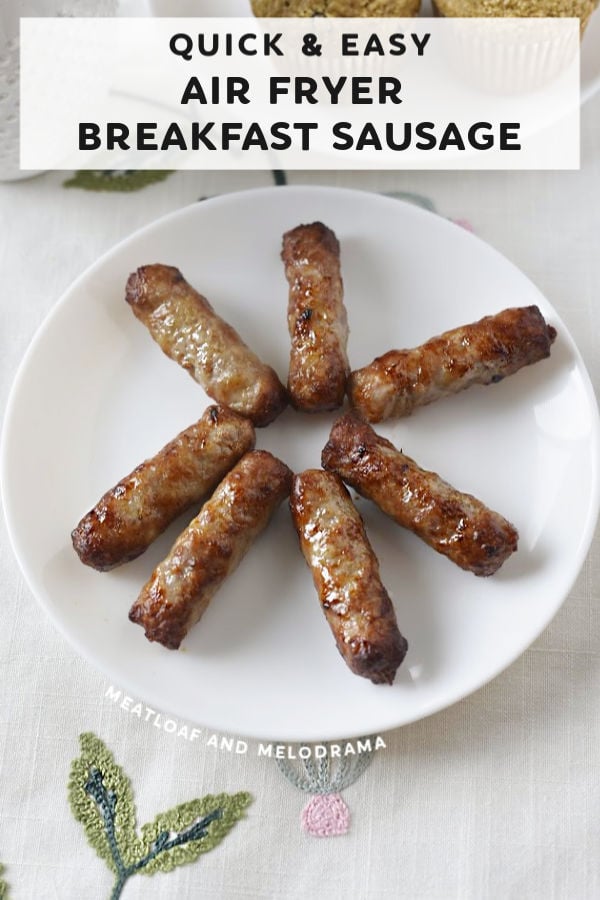 close up of sausage links on a white plate