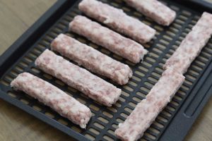 raw uncooked breakfast sausage links on Vortex plus tray