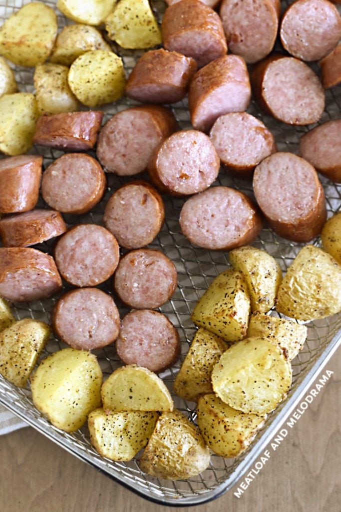 cooked kielbasa and potatoes in metal tray