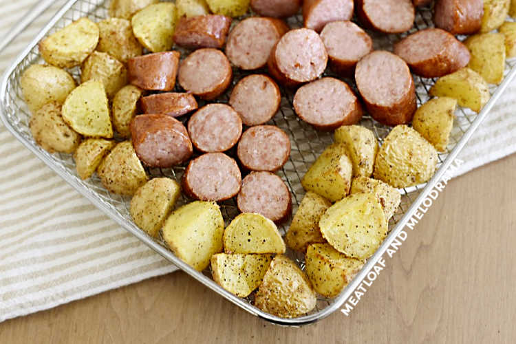 sliced air fried kielbasa and potatoes in basket