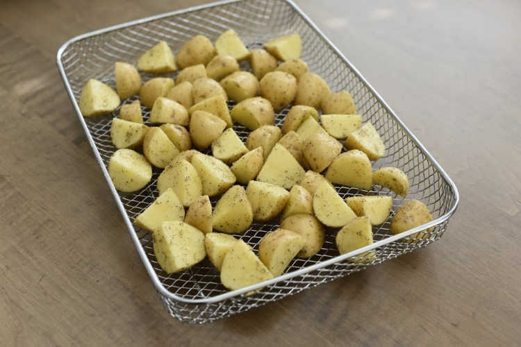 cut seasoned baby potatoes in cooking basket