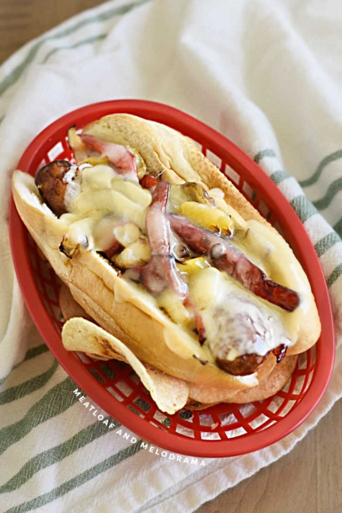 Italian sausage and peppers and onion sandwich covered with provolone cheese