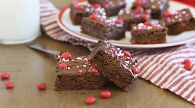 ancho chili brownies with cinnamon imperial candy topping on a red and white plate