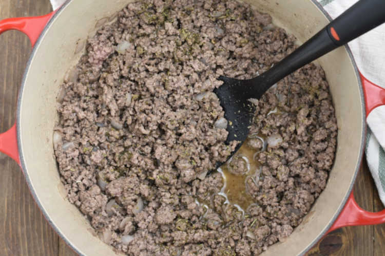 brown ground beef and onions in dutch oven
