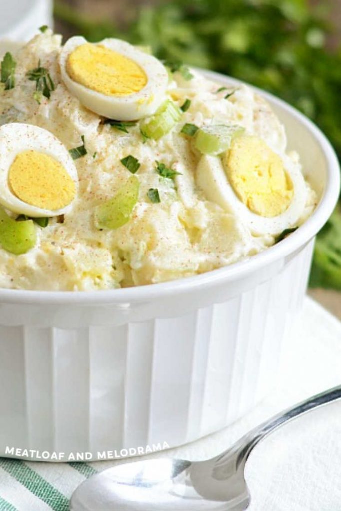 potato salad with hard boiled egg slices in white bowl