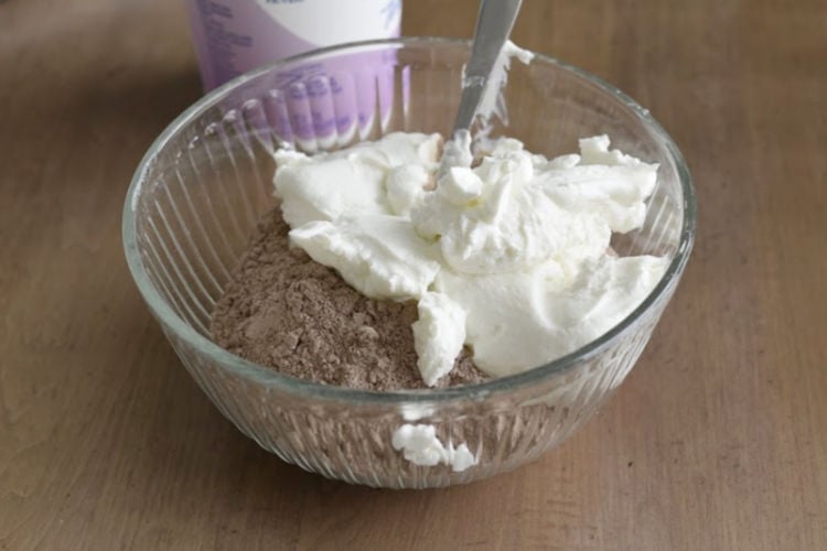 mix yogurt and chocolate cake mix in a mixing bowl
