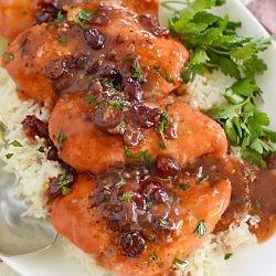chicken breasts with cranberry sauce on a platter