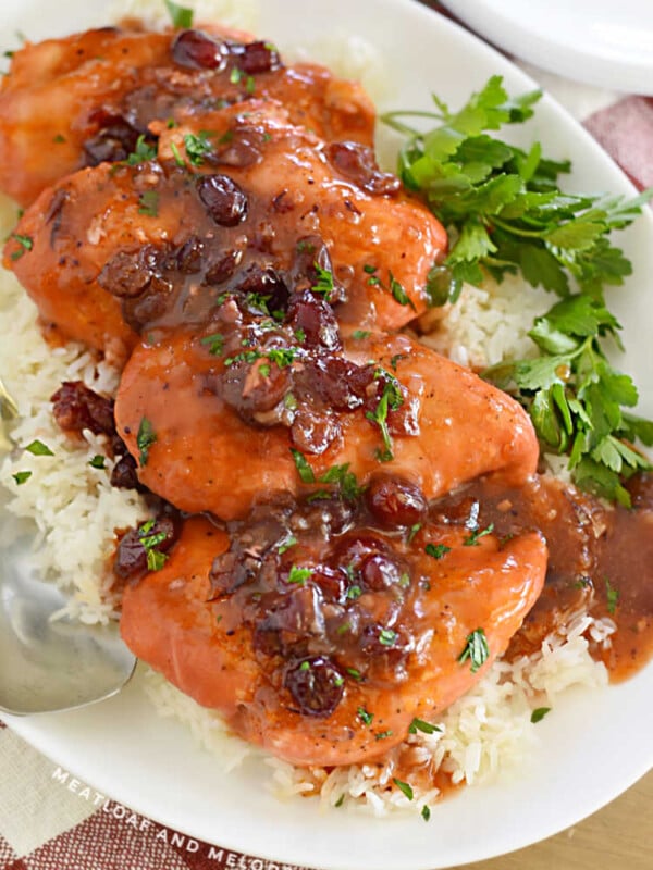 chicken breasts with cranberry sauce on a platter