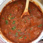 homemade spaghetti sauce in a dutch oven with parsley
