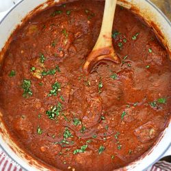 homemade spaghetti sauce in a dutch oven with parsley