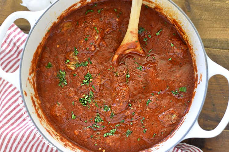 homemade spaghetti sauce in a dutch oven with parsley