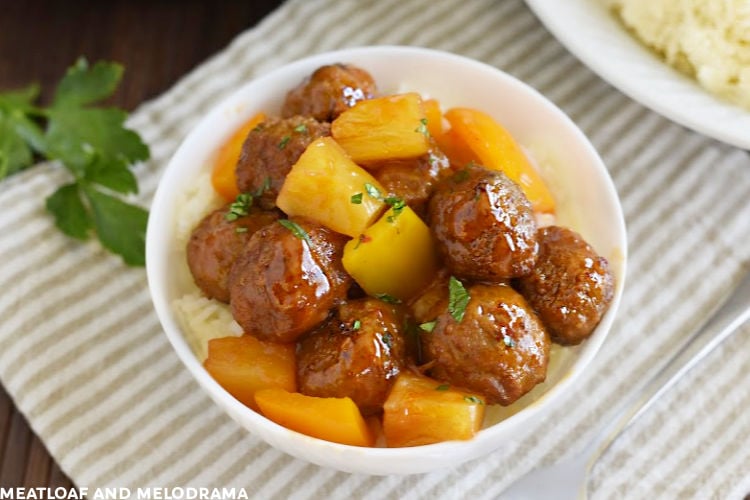 sweet and sour meatballs with pineapple and yellow bell peppers in a white bowl