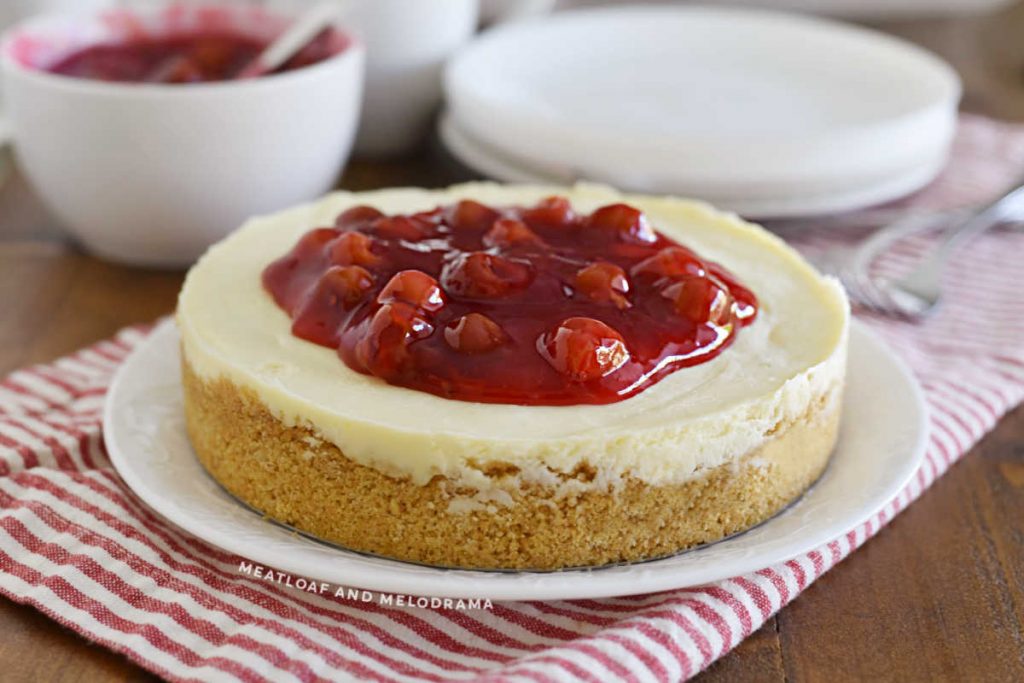 instant pot cheesecake with graham cracker crust and cherry pie filling on top