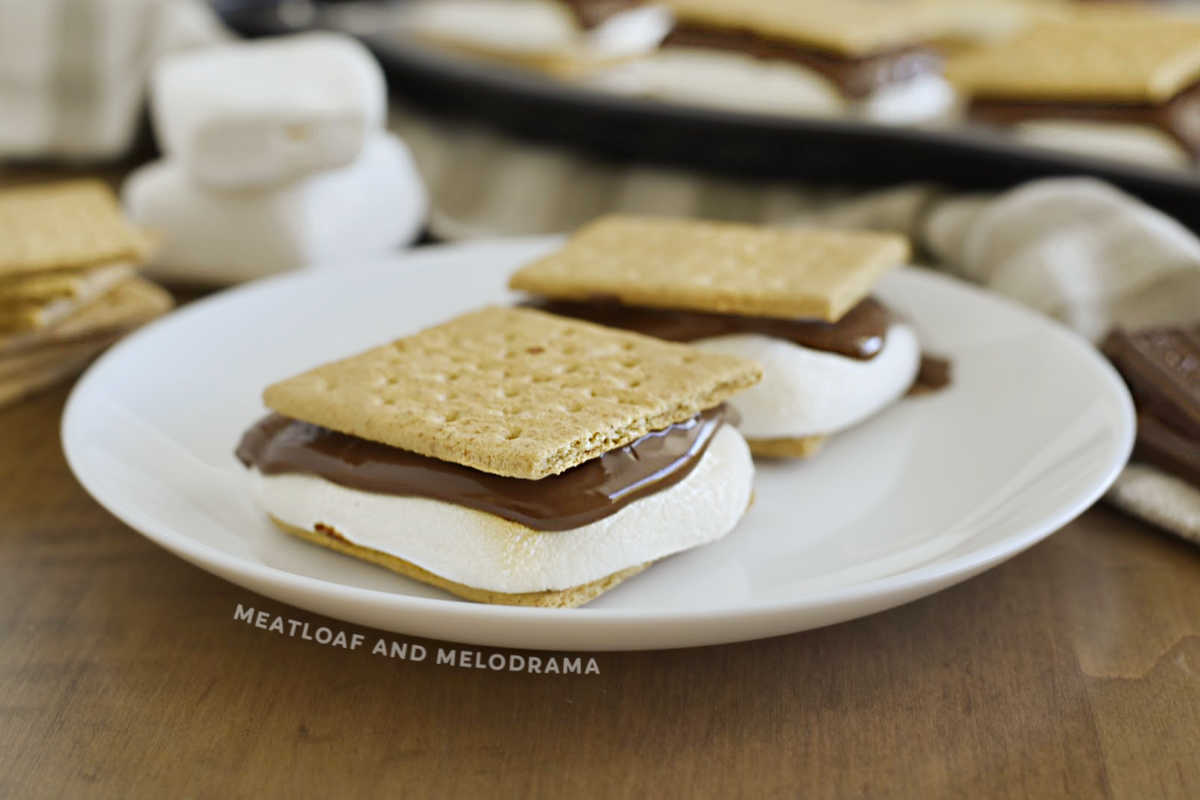 s'mores with graham cracker, marshmallow and melted chocolate on a white plate