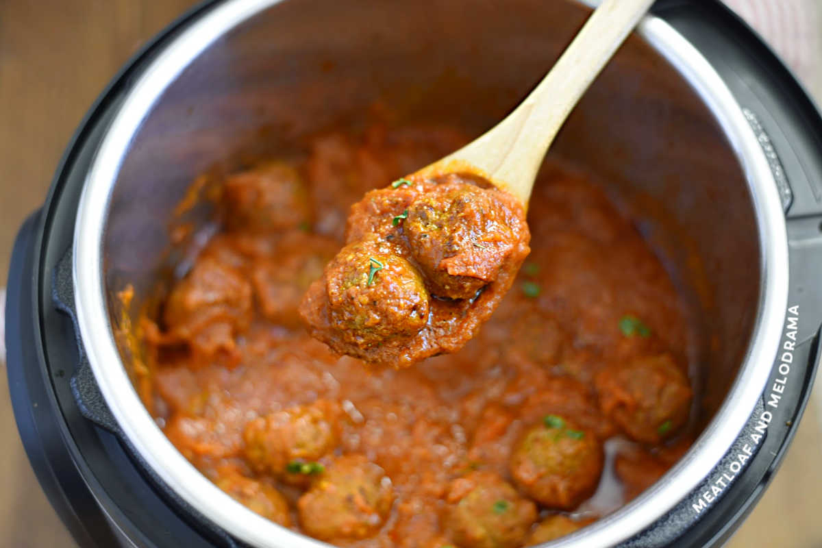 cooked meatballs in sauce in wooden spoon over instant pot