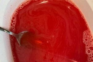 mix strawberry jello gelatin with hot and cold water