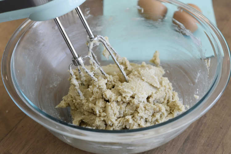 hand mixer with butter and sugar in a bowl