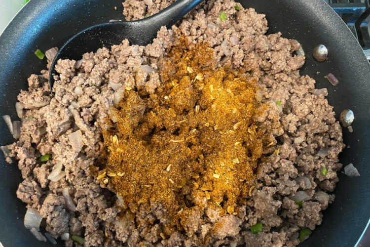 add taco seasoning to browned ground beef in skillet