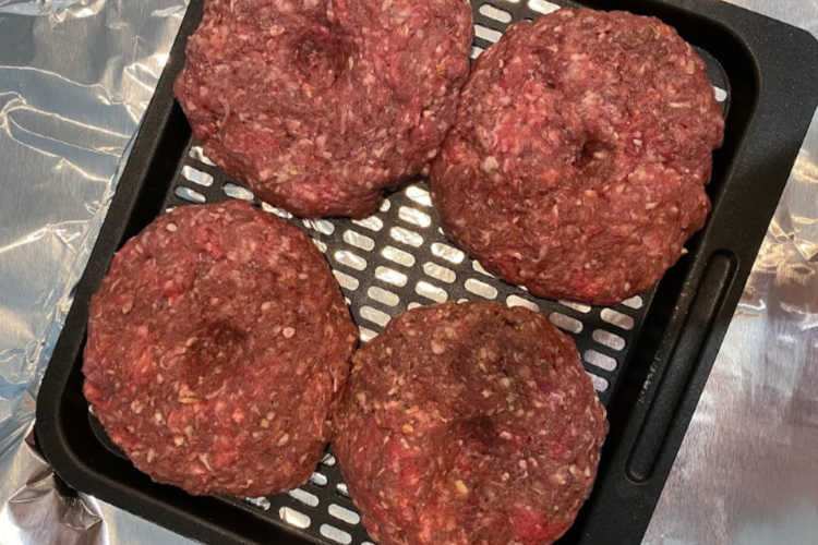 ground beef patties on air fryer tray