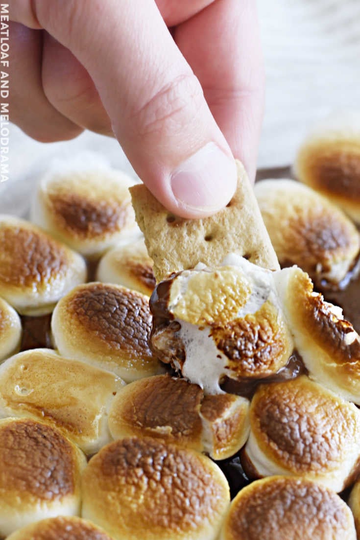 melted chocolate and marshmallows on graham cracker