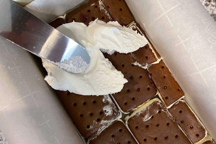 spread whipped topping over ice cream sandwiches