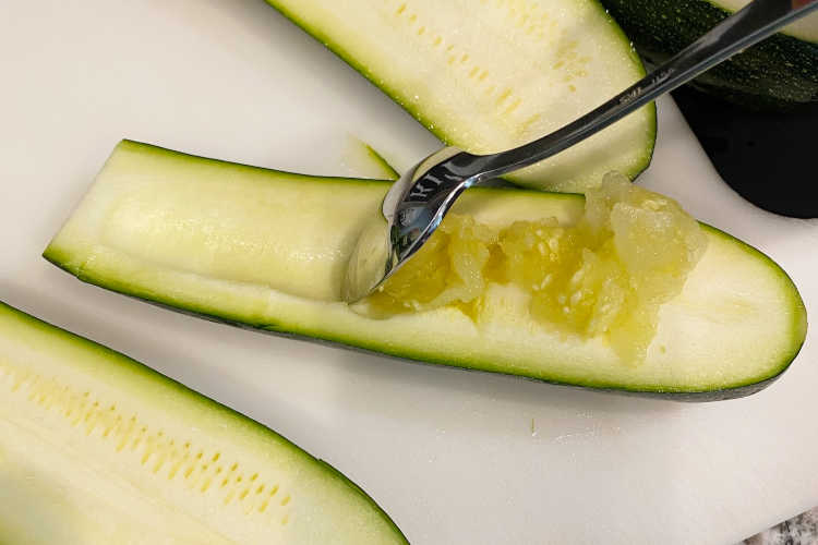 scrape zucchini with teaspoon