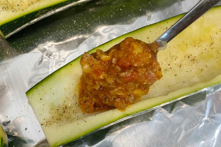 spoon filling into zucchini