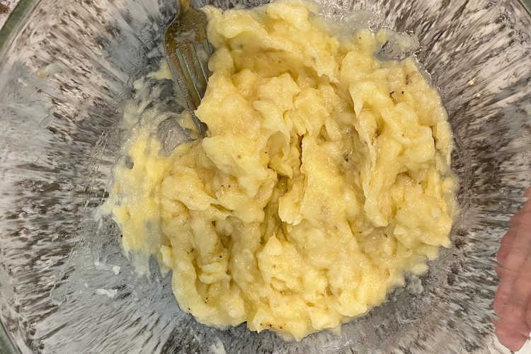 mash bananas in mixing bowl